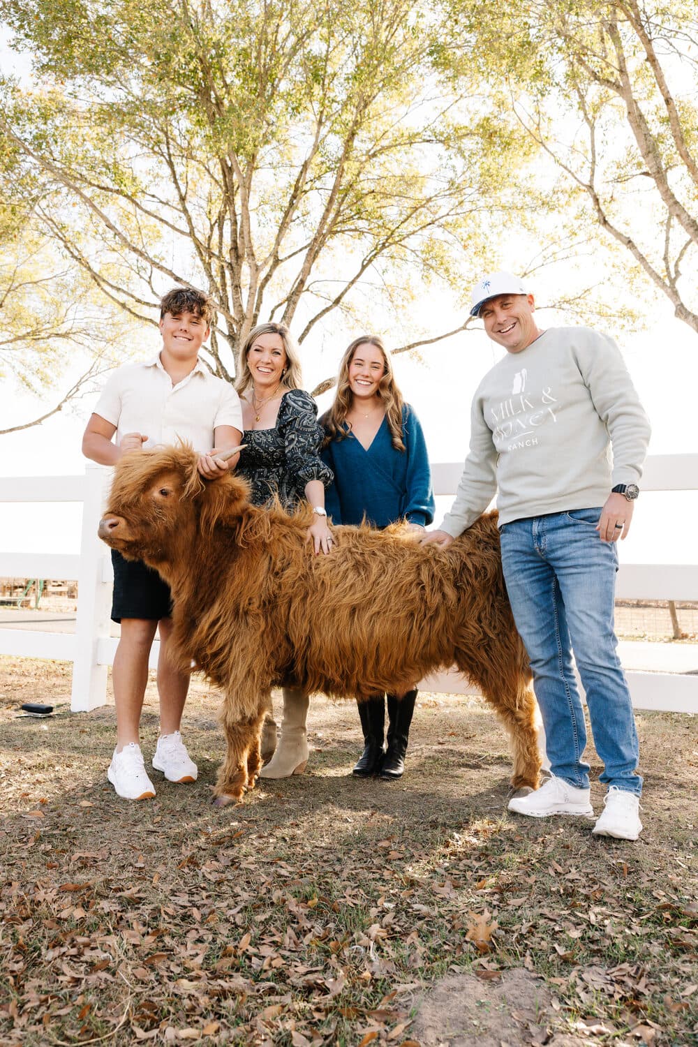 The Phillips family with one of the ranch's highland cows